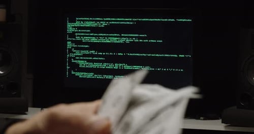 Hand Holding Money With Computer Screen Background