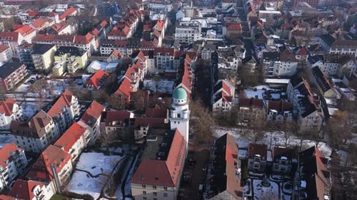Aerial Survey of Ostmannturm in Bielefeld Germany with Red Roofs and Lingering Snow in Winter