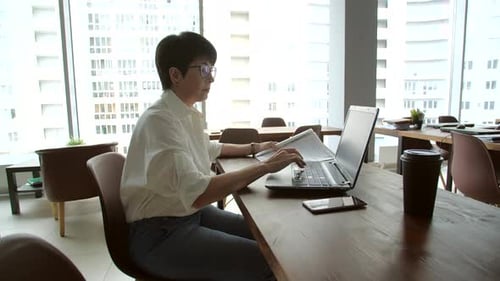 Attractive Mature Businesswoman Working on Laptop in Office or Coworking