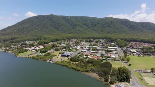 Aerial view of coastal homes and greenery, Australia.