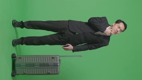 Full Body Of Businessman With Luggage Thinking About Something While Standing In The Green Screen