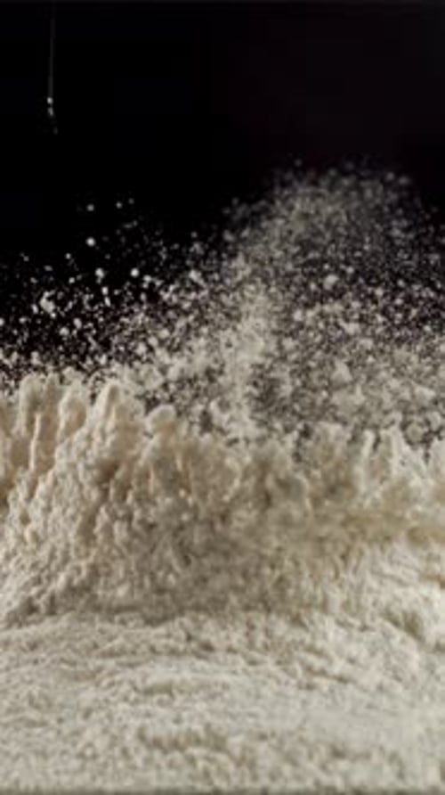 Super Slow Motion in a Pile of Flour on the Table Drops Raw eggFilmed on a Highspeed Camera at 1000