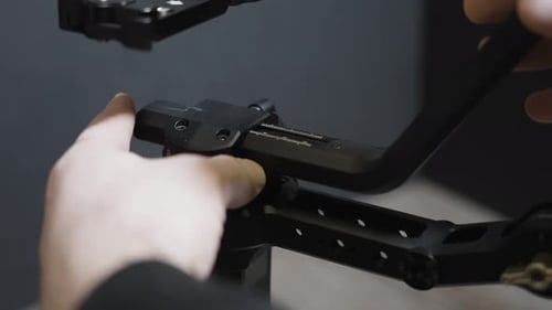 Hands Adjusting Camera Stabilizer Close Up