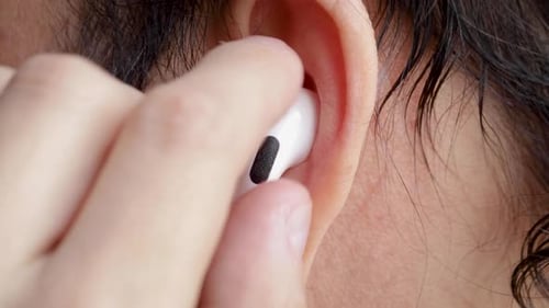 Wireless Earbud Being Inserted into an Ear
