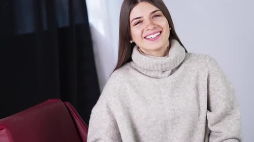Woman Smiling and Posing in a Cozy Sweater