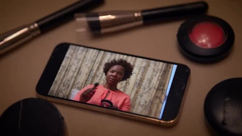 Mobile Phone Showing Woman Applying Blush