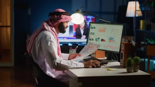 Young Adult Working at Computer in Home Office
