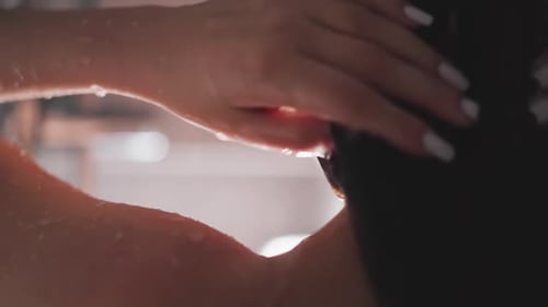 Woman Washing Long Black Hair in Shower