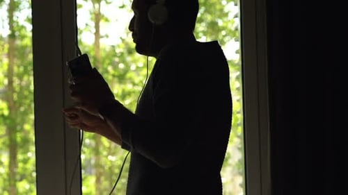 Man listening to music and dancing indoors