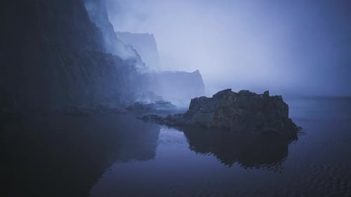 Fog Envelops Rocky Coastal Landscape Near the Sea at Dawn