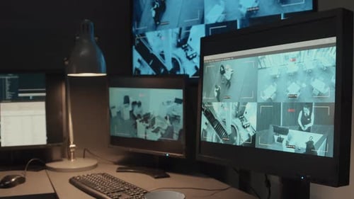 Surveillance Monitors in a Dark, Modern Office