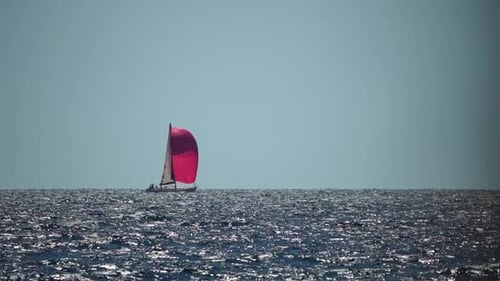 Sailing Ship Luxury Yacht with Red Sails in the Sea in the Evening Sunlight