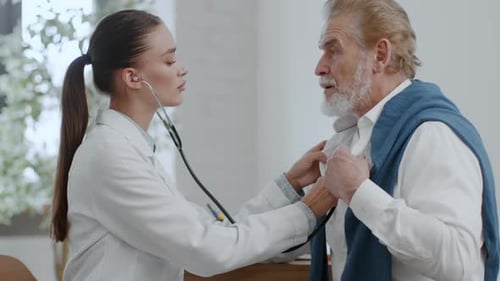 Doctor Listening to Senior Patient with Stethoscope