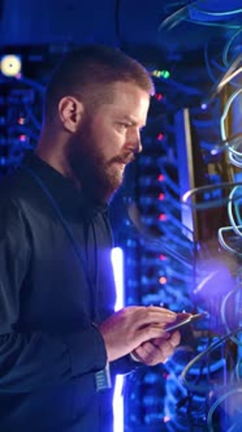 Man Checks Data Servers on Mobile Device