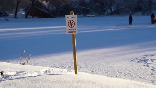 Snowy Landscape With Warning Sign in Winter