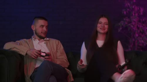 Young Couple Playing Video Games on Couch