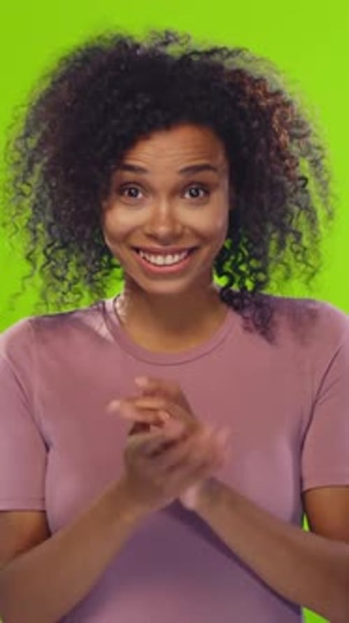 Woman Expressing Surprise in Front of Green Screen Background