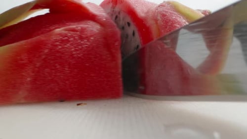 Pitahaya or dragon fruit with white flesh, I cut it in half. Dolly slider extreme close-up.