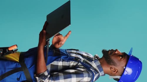 Vertical Video Modern Constructor Using Laptop to Find Inspiration