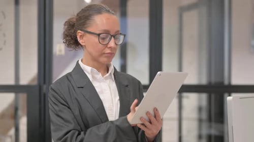 Professional Woman Using Tablet in Office Setting