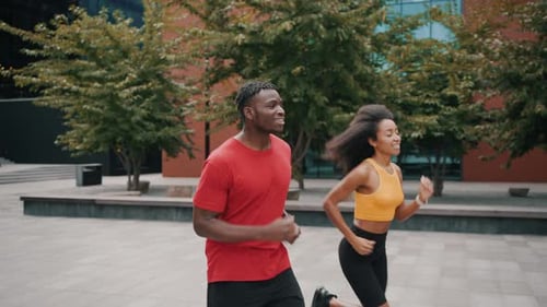 Lovely Married Couple Enjoying Jog Together on Urban Area