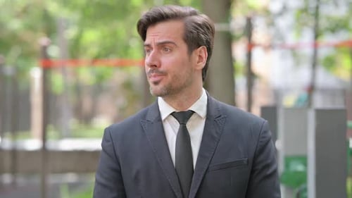 Portrait of Waiting Young Businessman Checking Time Outdoor