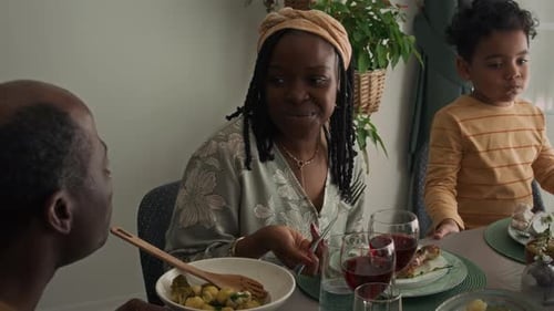 Family Meal Shared at Dining Room Table