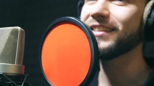 Unrecognizable Male Singer in Headphones Singing Song at Sound Studio Young Man Emotionally