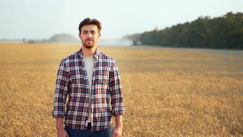 Portrait of Happy Farmer Standing in Ripe Wheat Field with Arms Crossing on Chest Proud Agronomist