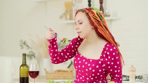 Woman Eating Salad in Kitchen