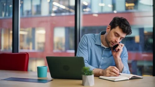 Young Adult Talking on Phone in Modern Office