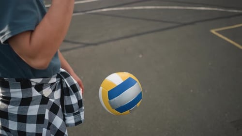 Person Bouncing Volleyball on Outdoor Court