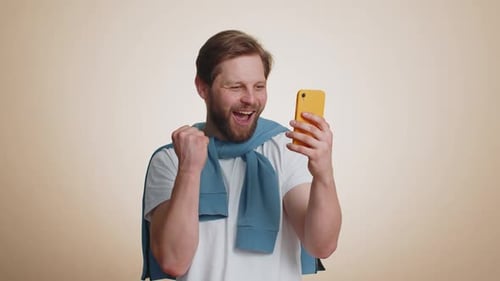 Excited Man Reacts to Good News on Phone