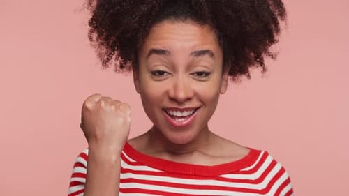 Excited Woman Celebrating Success with Fist Pump