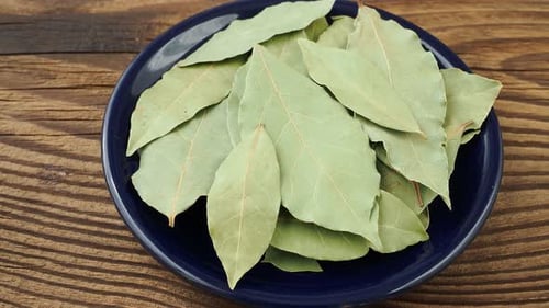 Dried bay leaves in ceramic bowl