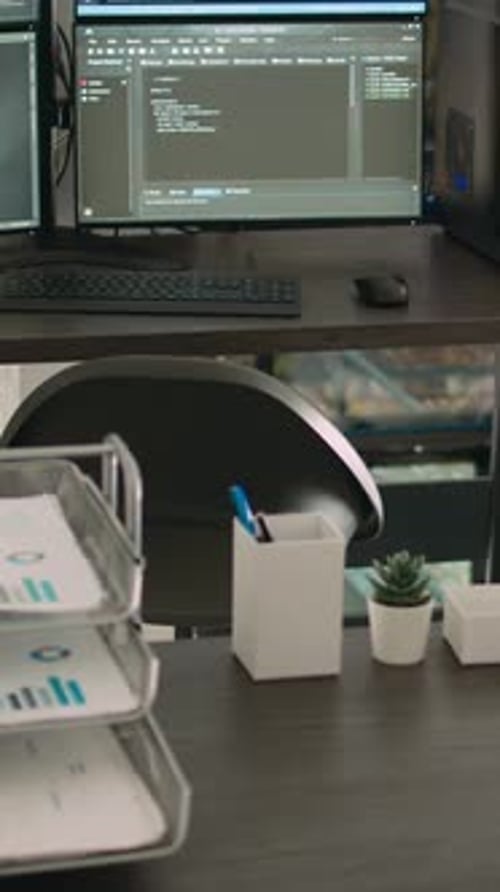 Vertical Video Computer Monitors Showing Parsing Code in Empty It Agency Office