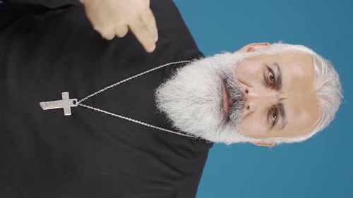 Vertical Video of The Christian man also makes the sign of the cross. Close-up of Christian man.