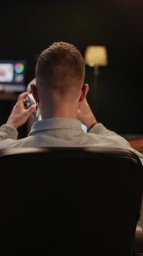 Retoucher Putting Off Headphones and Turning to Camera