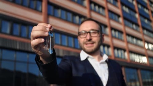 Business Man in Suit Posing with Keys Buying New Flat City House Mortgage Financial Investment Loan