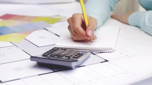 Designer plans with pencil, calculator, and swatches