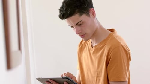 Young Adult Using Tablet Device Indoors