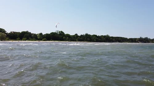 kite surfer glide over the water near the beach
