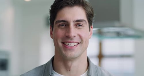 4k video footage of a handsome young man spending the day at home