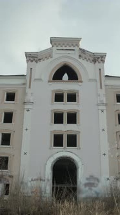 Tall Derelict Structure High Arched Window Dominates Facade Ghost Resembling Suicide Victim Stands