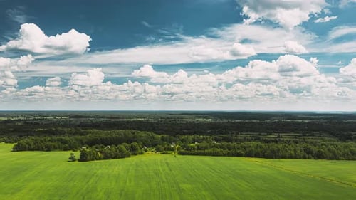 Sky With Clouds On Horizon Above Rural Landscape Young Green Wheat Field Spring Agricultural Green