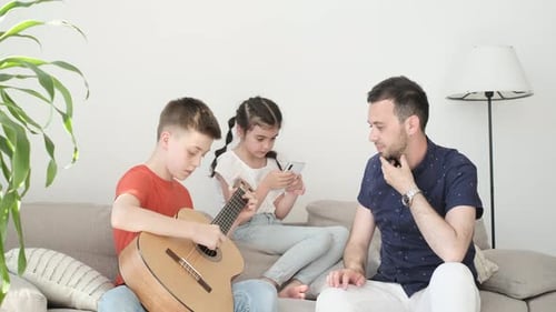 Father and Children Relaxing on Couch Together