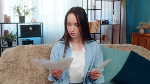 Frustrated Woman Throws Papers in Air at Home