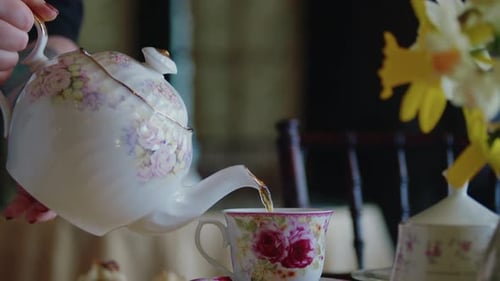 Tea Being Poured from Elegant Teapot Into Teacup