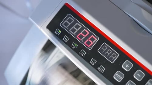 Electronic cash counting equipment working. Unrecognized banknotes turning quickly in machine