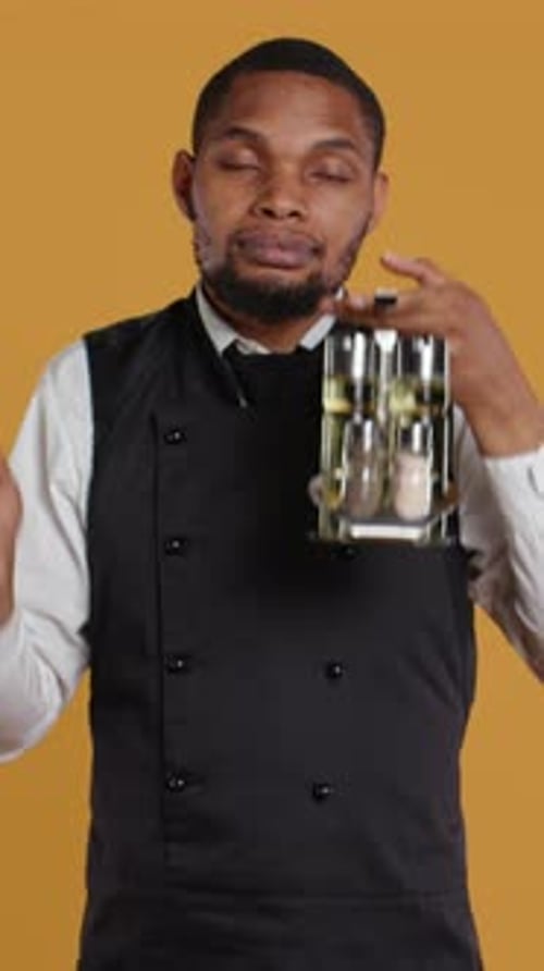 Restaurant employee holding condiments presents them to camera